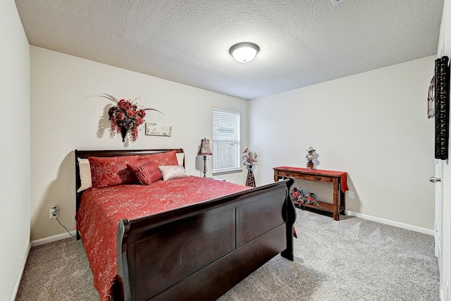 bedroom featuring a textured ceiling and carpet floors