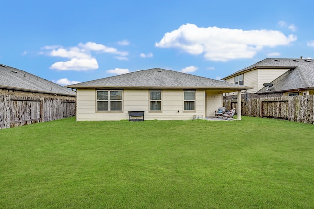 rear view of house featuring a yard and a patio area