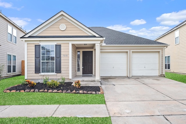 view of front facade with a front yard and a garage