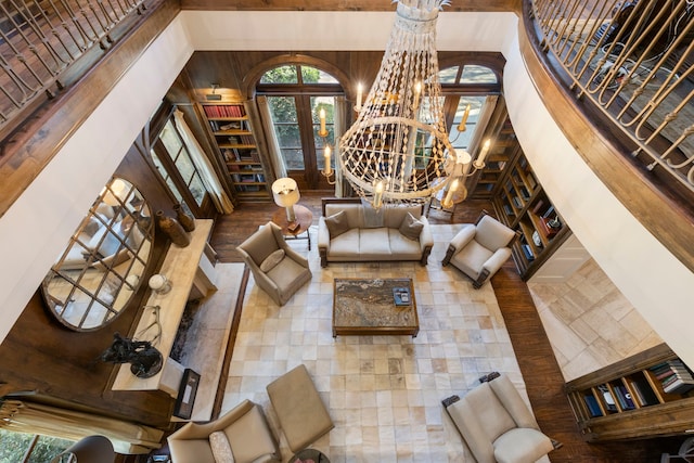 living room with a notable chandelier and a high ceiling