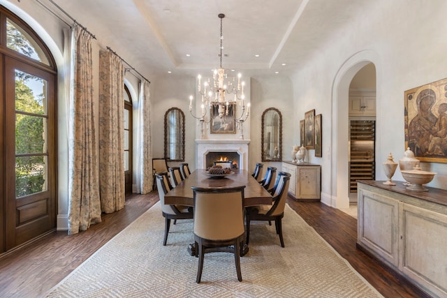 dining area featuring dark hardwood / wood-style floors and a tray ceiling