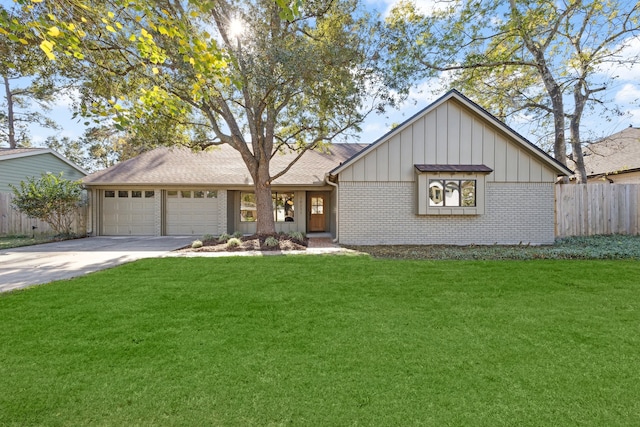 view of front of house featuring a front yard and a garage