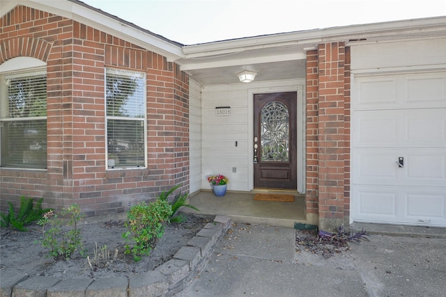 view of exterior entry with a garage