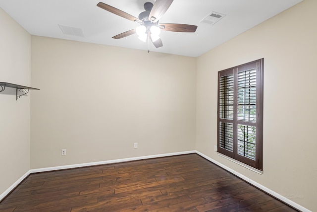 empty room with ceiling fan and dark wood-type flooring