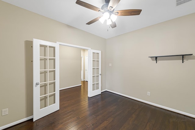 unfurnished room with ceiling fan, dark wood-type flooring, and french doors