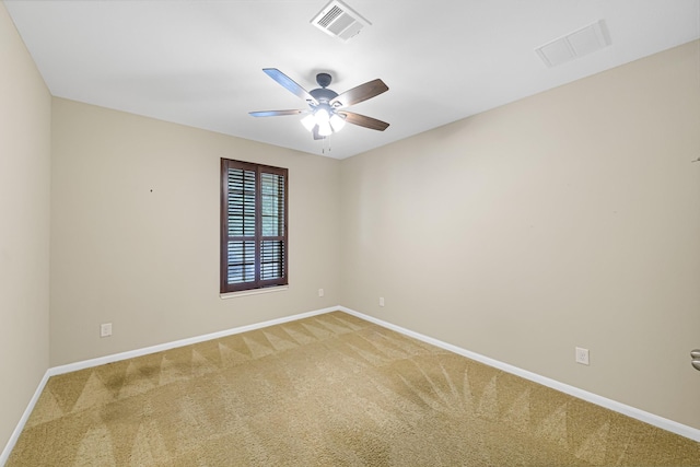 carpeted spare room featuring ceiling fan