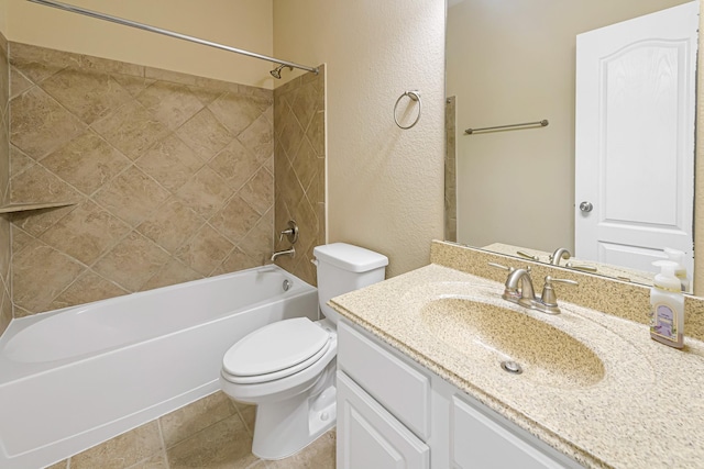 full bathroom with vanity, tiled shower / bath combo, and toilet