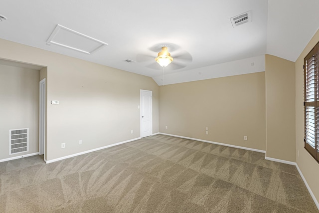 carpeted empty room with ceiling fan and vaulted ceiling