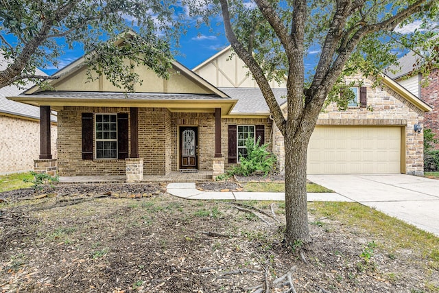 view of front of home featuring covered porch and a garage