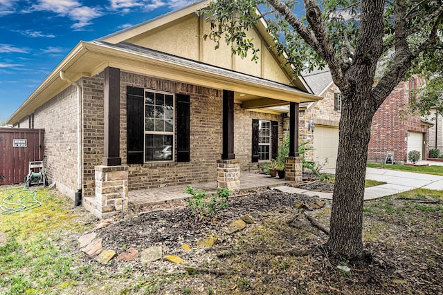 view of front of property featuring covered porch and a garage