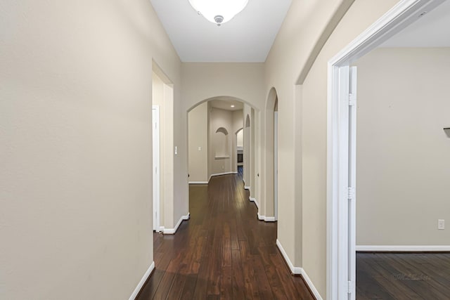 corridor with dark hardwood / wood-style floors