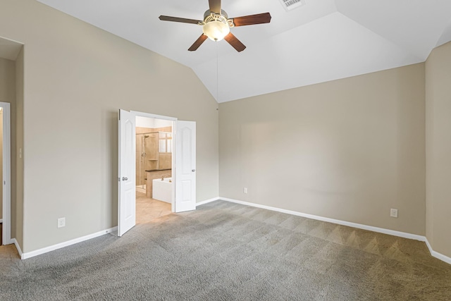 unfurnished bedroom with lofted ceiling, ceiling fan, light carpet, and connected bathroom