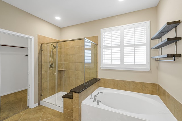 bathroom featuring plus walk in shower and tile patterned floors