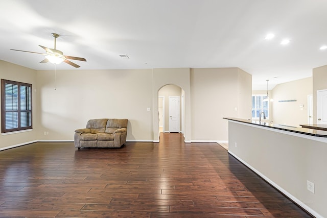 unfurnished room with sink, ceiling fan, and dark hardwood / wood-style floors