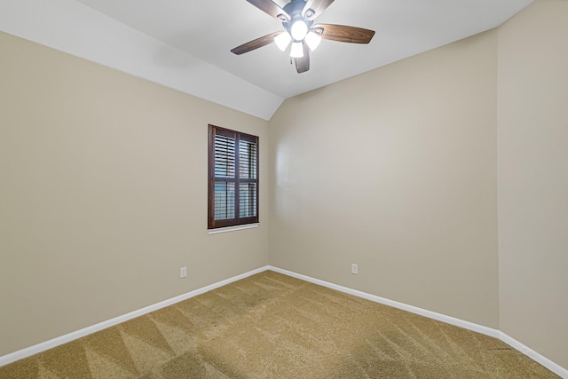 spare room with vaulted ceiling, ceiling fan, and carpet flooring