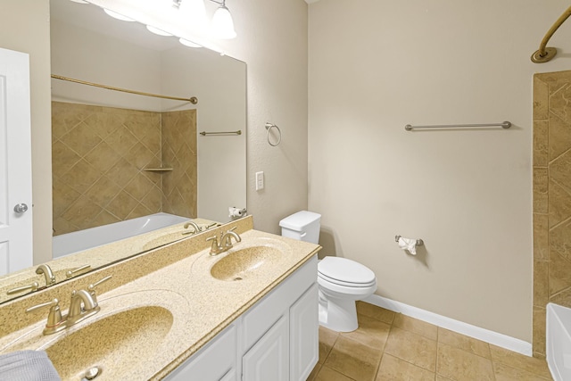 full bathroom with toilet, tiled shower / bath combo, tile patterned floors, and vanity