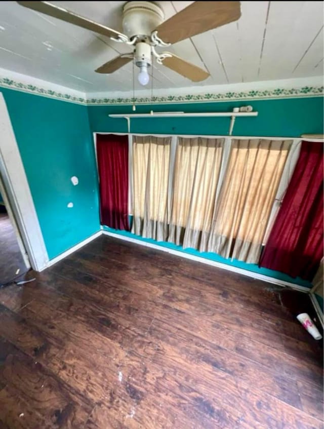 spare room featuring ceiling fan and dark hardwood / wood-style floors