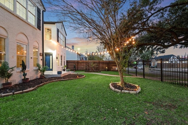 view of yard at dusk