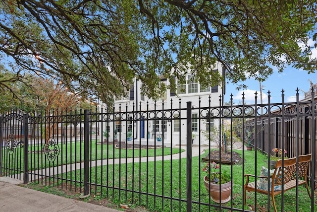 view of gate featuring a yard