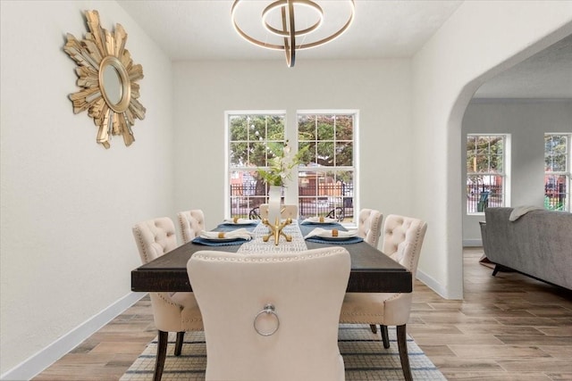 dining area featuring a chandelier and light hardwood / wood-style flooring