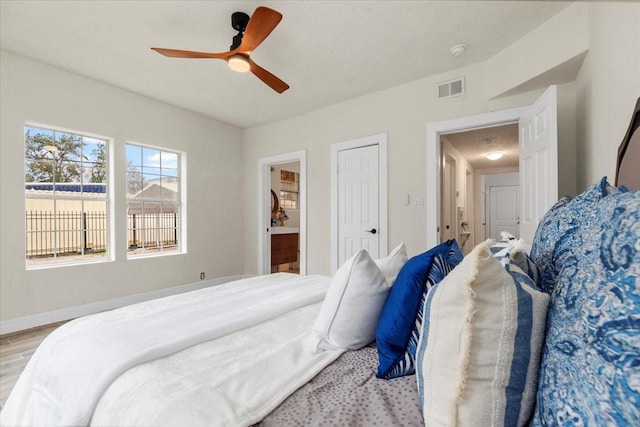 bedroom with ceiling fan and light hardwood / wood-style floors