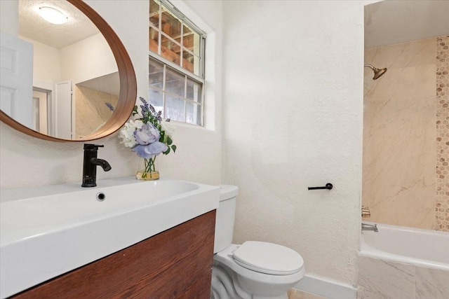 full bathroom with toilet, vanity, a textured ceiling, and tiled shower / bath combo