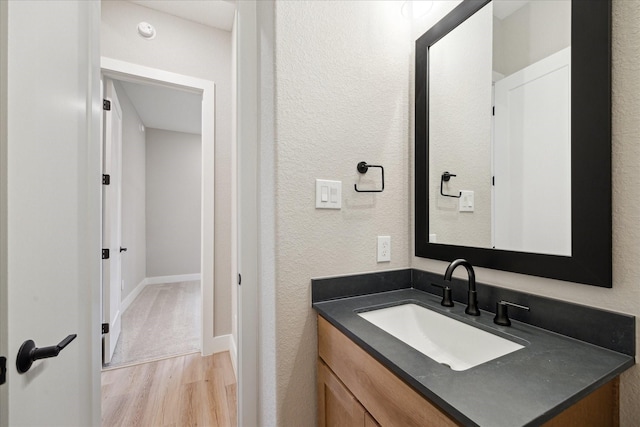 bathroom featuring hardwood / wood-style flooring and vanity