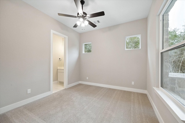 unfurnished room with light carpet, ceiling fan, and a healthy amount of sunlight