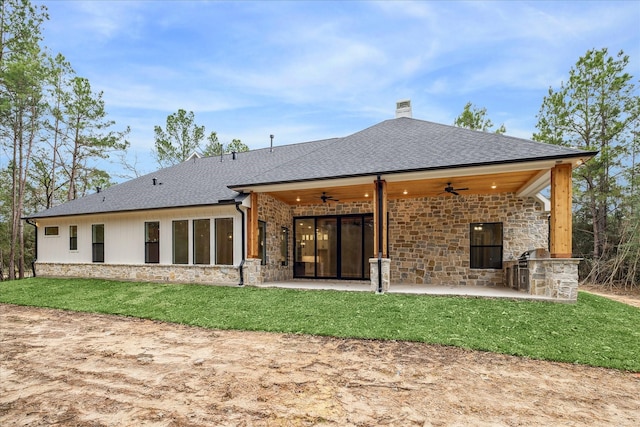 rear view of house with ceiling fan, a patio area, and a lawn