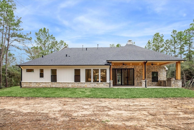 back of property with ceiling fan, a lawn, and a patio