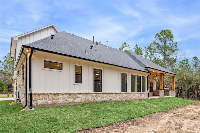 rear view of house featuring a patio and a yard