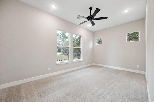 empty room featuring ceiling fan and carpet