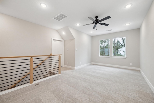 unfurnished room featuring light carpet and ceiling fan