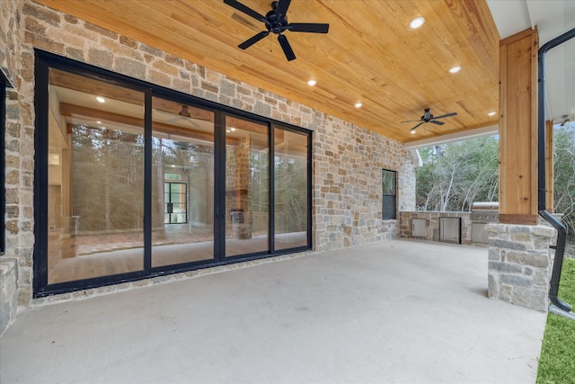 view of patio featuring ceiling fan and exterior kitchen