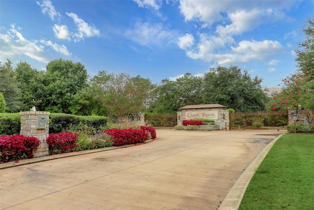 11502 Kate Ct, Montgomery, TX 77316 - exterior space featuring curbs, a gated entry, a gate, and view of wooded area