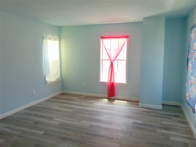 unfurnished room with wood finished floors and baseboards