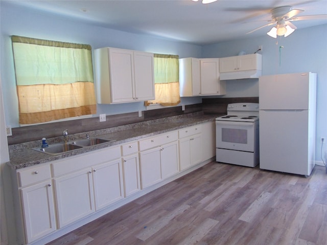 kitchen featuring sink, white appliances, and white cabinetry