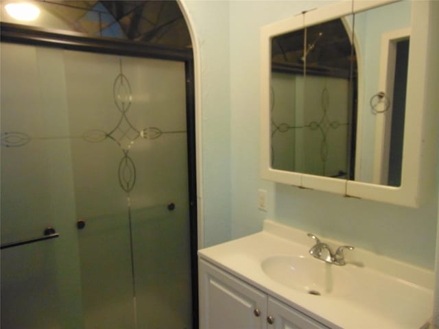 bathroom with a shower and vanity