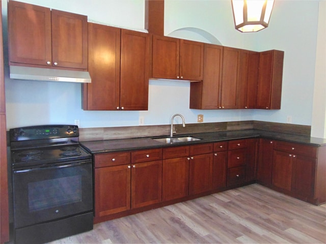 kitchen with black range with electric cooktop, light wood-type flooring, and sink