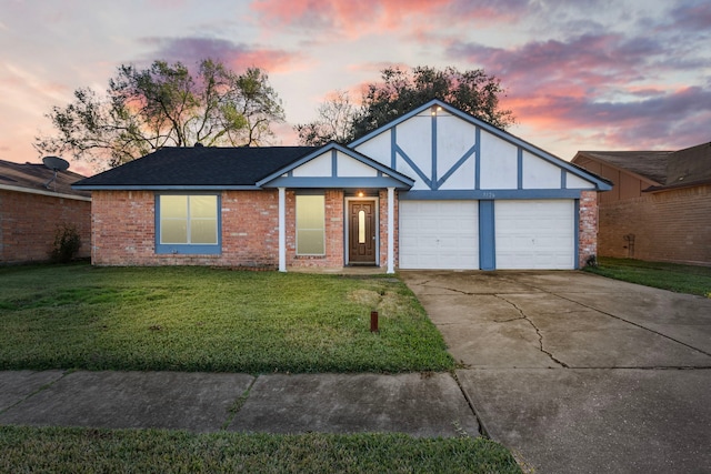 view of front of property featuring a lawn and a garage