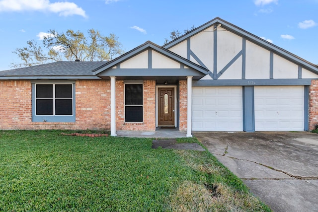 view of front of home with a front lawn and a garage