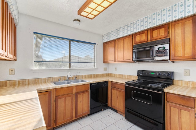 kitchen with a textured ceiling, light tile patterned floors, sink, and black appliances