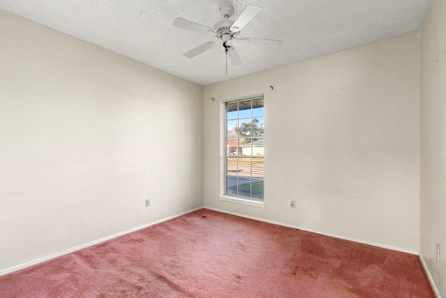 spare room with carpet floors, ceiling fan, and a textured ceiling