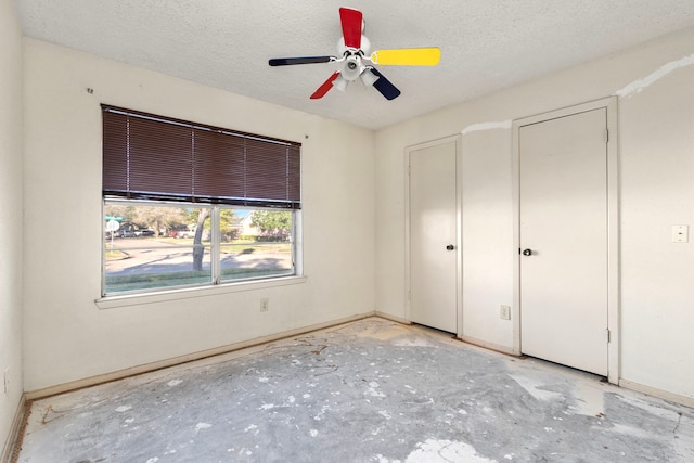 unfurnished bedroom with a textured ceiling and ceiling fan