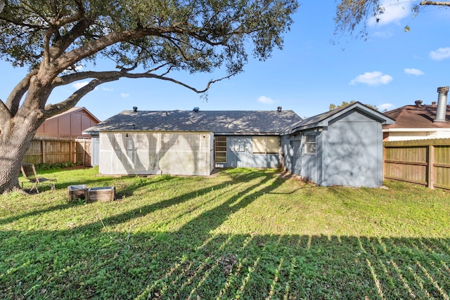 rear view of property featuring a lawn