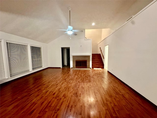 unfurnished living room with ceiling fan, vaulted ceiling, and wood-type flooring