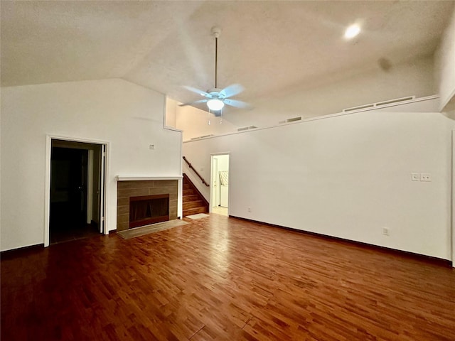 unfurnished living room with ceiling fan, vaulted ceiling, and dark hardwood / wood-style floors