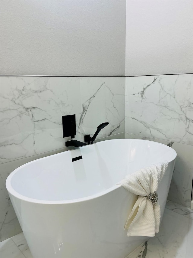 bathroom featuring tile walls and a tub to relax in