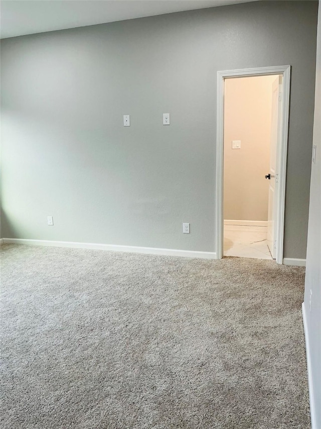 unfurnished room featuring light carpet