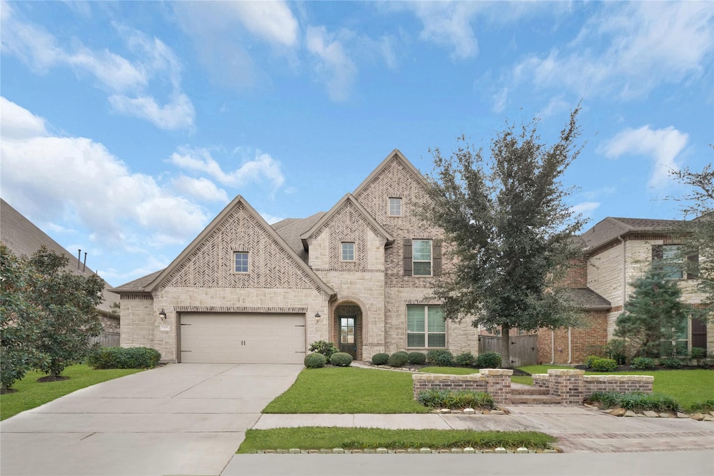 view of front of home with a front lawn and a garage